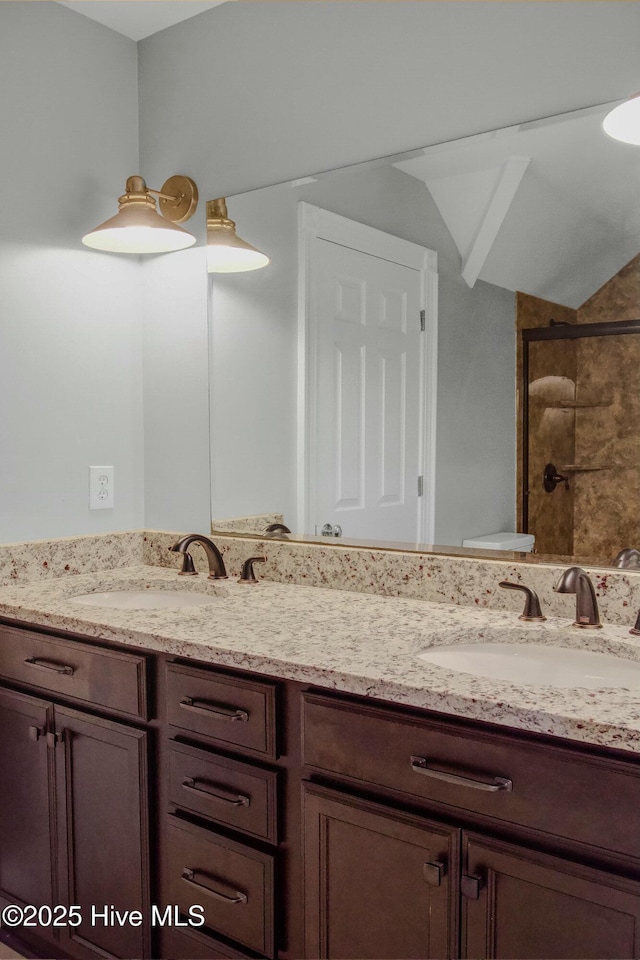 bathroom with lofted ceiling, vanity, toilet, and tiled shower