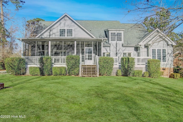 rear view of house with a sunroom and a yard