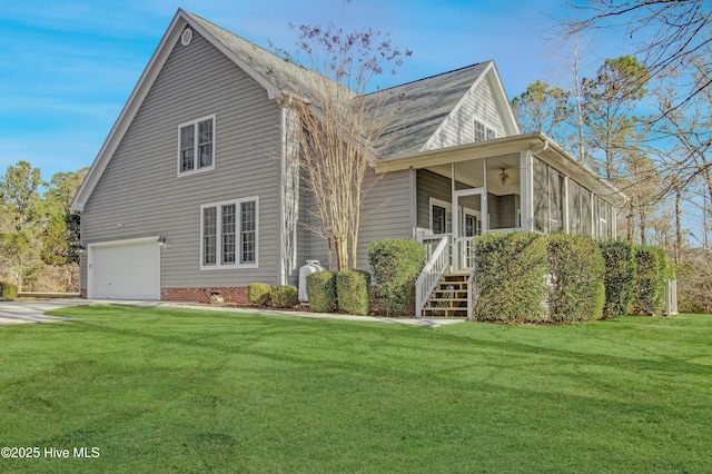 view of front of home featuring a front lawn, a garage, and a sunroom