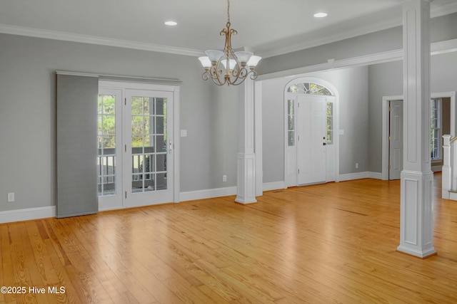 interior space with decorative columns and a healthy amount of sunlight