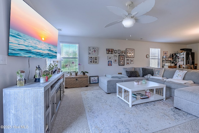 living room with ceiling fan and a wealth of natural light