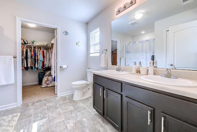 bathroom featuring vanity, toilet, and walk in shower