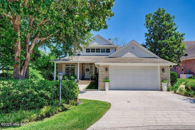 view of front of property with a garage and covered porch