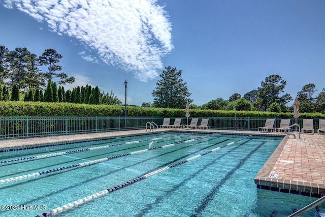 pool with fence and a patio area