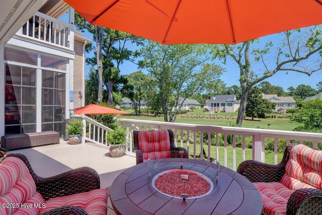 deck with a yard and outdoor dining space
