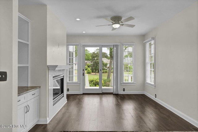 kitchen featuring stone counters, ceiling fan, white cabinets, and dark wood-type flooring