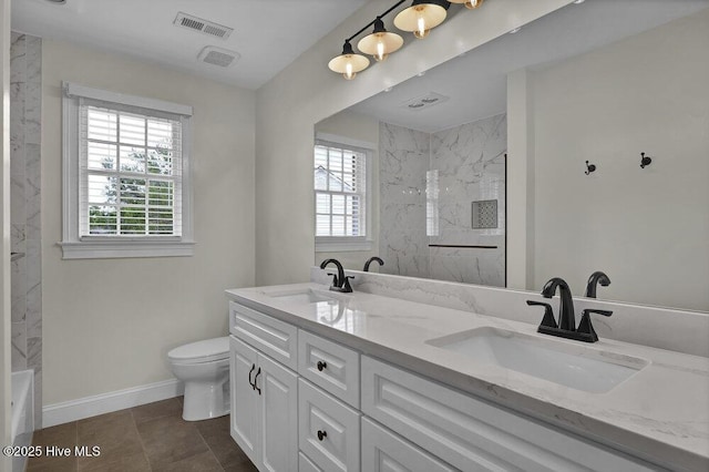 full bathroom featuring a sink, a healthy amount of sunlight, and toilet