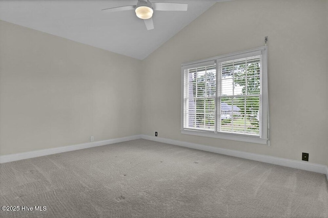 carpeted empty room with baseboards, ceiling fan, and vaulted ceiling