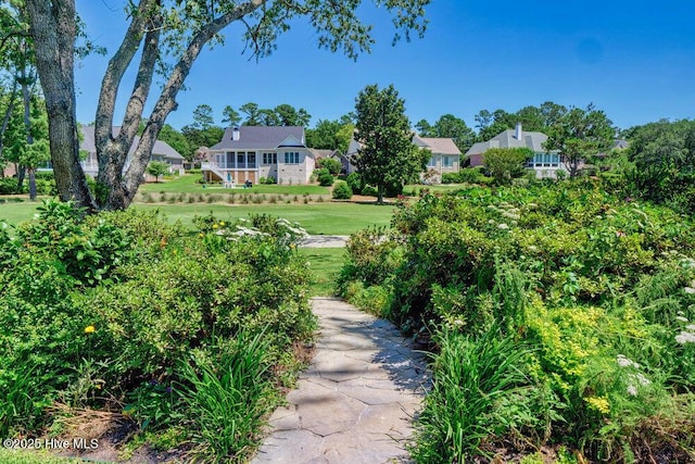 view of property's community with a yard