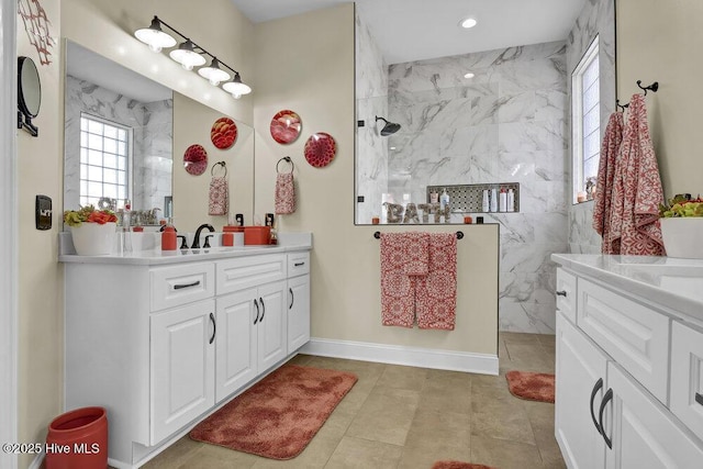 bathroom with vanity, recessed lighting, a marble finish shower, and baseboards