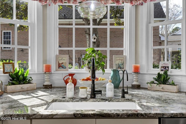 room details featuring a sink and stone counters