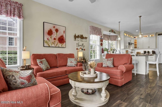 living room with dark wood-style flooring and a ceiling fan
