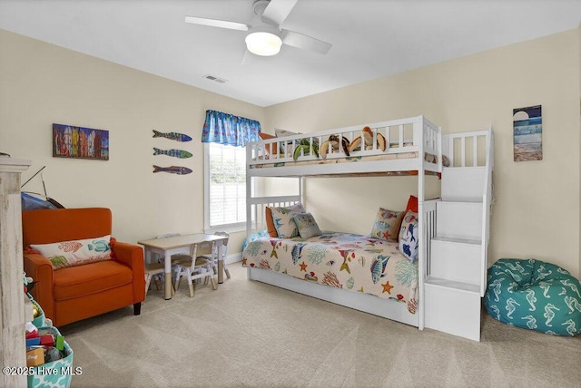 carpeted bedroom with a ceiling fan and visible vents