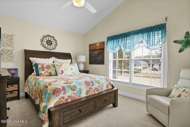 carpeted bedroom with baseboards, a ceiling fan, and high vaulted ceiling