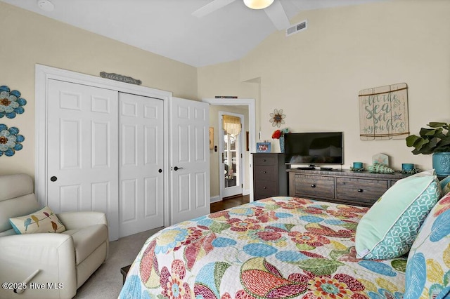 carpeted bedroom featuring visible vents, a closet, ceiling fan, and lofted ceiling