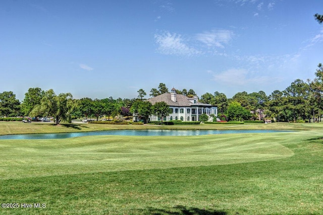 surrounding community with a yard and a water view