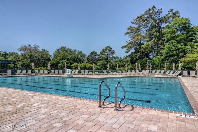 community pool featuring a patio and fence