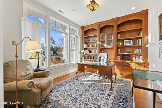 office space featuring visible vents, recessed lighting, baseboards, and wood finished floors