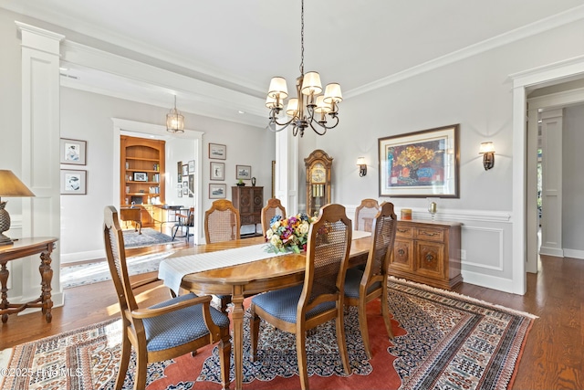 dining room with built in features, a notable chandelier, wood finished floors, and crown molding