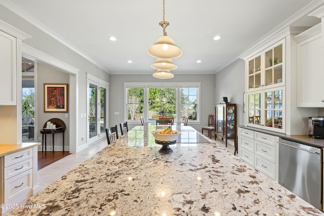 kitchen featuring light stone countertops, ornamental molding, white cabinets, glass insert cabinets, and dishwasher