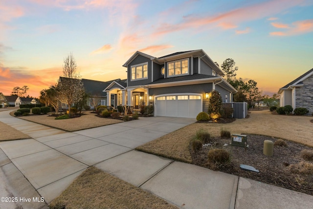 view of front of property featuring cooling unit, an attached garage, and concrete driveway