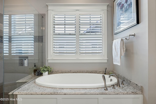 full bathroom with plenty of natural light and a bath