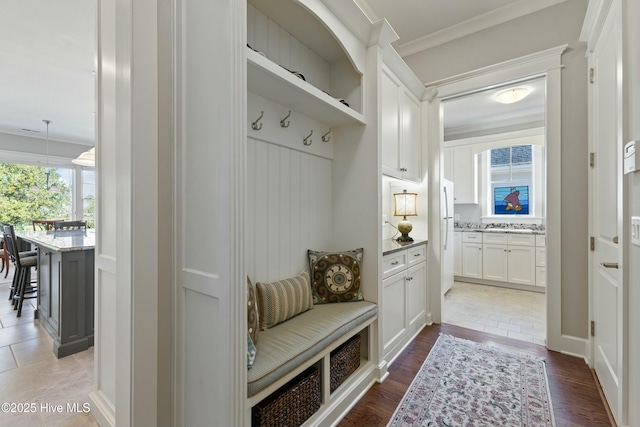 mudroom featuring crown molding and light wood finished floors