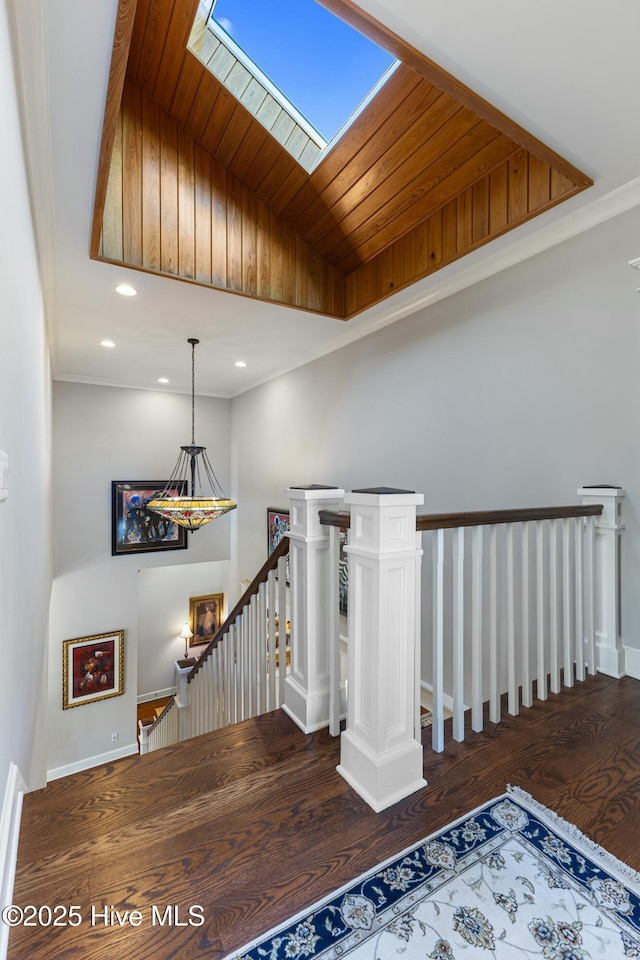 staircase with recessed lighting, baseboards, wood ceiling, and wood finished floors