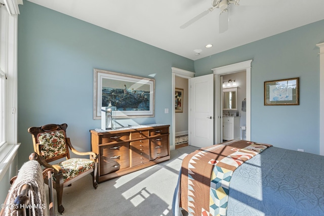 bedroom with baseboards, ensuite bathroom, a ceiling fan, and carpet floors