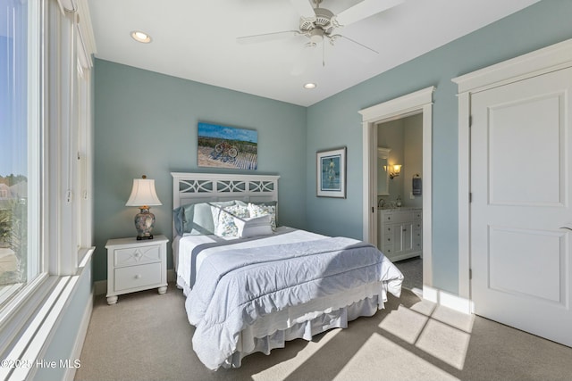 bedroom with baseboards, recessed lighting, connected bathroom, and carpet