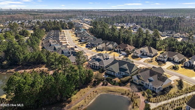 birds eye view of property featuring a residential view, a wooded view, and a water view