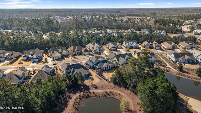 drone / aerial view with a residential view and a water view