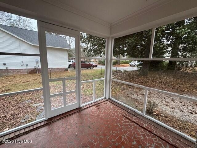 unfurnished sunroom featuring a wealth of natural light