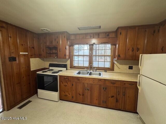 kitchen featuring sink and white appliances