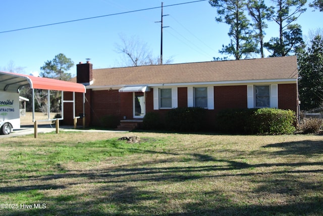 view of front facade with a carport and a front yard