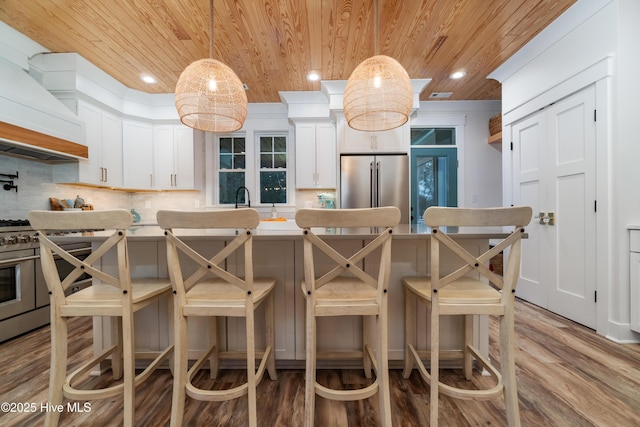 kitchen featuring premium range hood, white cabinetry, wood ceiling, decorative light fixtures, and appliances with stainless steel finishes