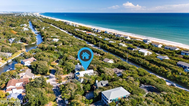 birds eye view of property featuring a water view and a view of the beach