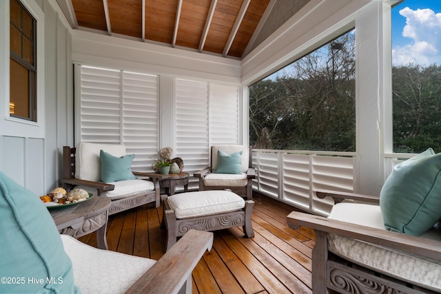 sunroom / solarium featuring lofted ceiling and wooden ceiling