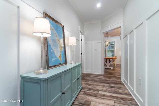 corridor featuring crown molding and dark hardwood / wood-style flooring