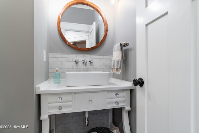 bathroom featuring vanity and backsplash