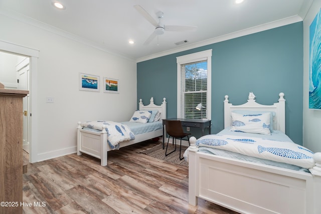 bedroom with ceiling fan, ornamental molding, and light wood-type flooring