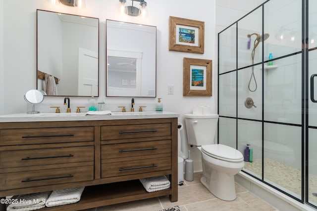 bathroom featuring vanity, toilet, and an enclosed shower