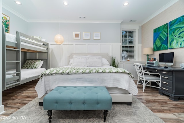 bedroom with crown molding and dark hardwood / wood-style floors