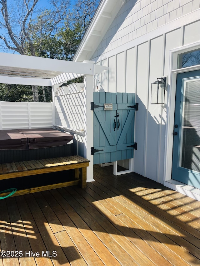 deck with a covered hot tub