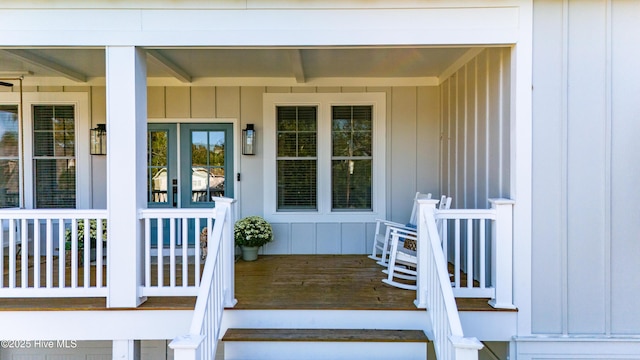 view of exterior entry with a porch