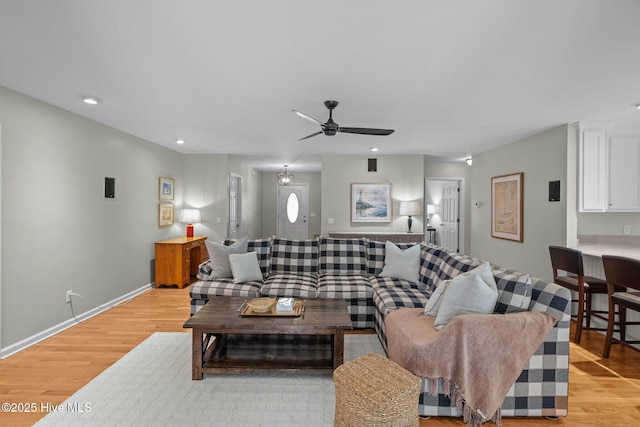 living area with recessed lighting, light wood-type flooring, baseboards, and ceiling fan