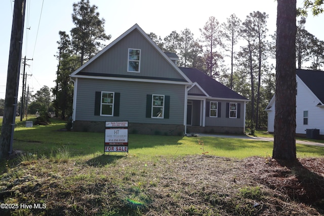 11 Pine Shore Dr, Southport, NC 28461 - view of front facade featuring a front lawn and central AC unit
