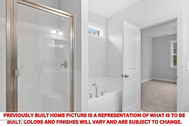11 Pine Shore Dr, Southport, NC 28461 - bathroom featuring a stall shower, a bath, and baseboards