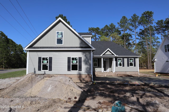 11 Pine Shore Dr, Southport, NC 28461 - view of front of property featuring a shingled roof and covered porch