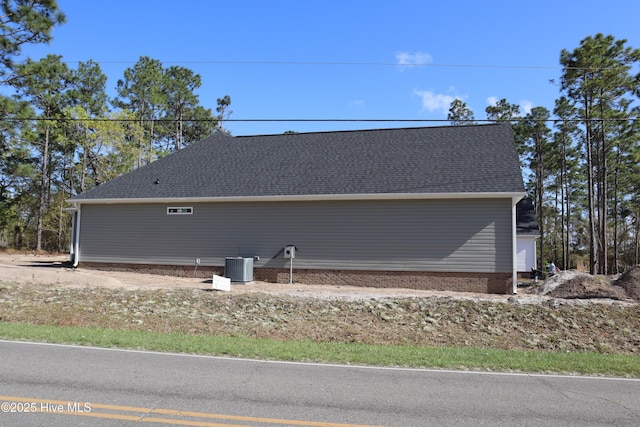 11 Pine Shore Dr, Southport, NC 28461 - view of home's exterior with central AC and a shingled roof
